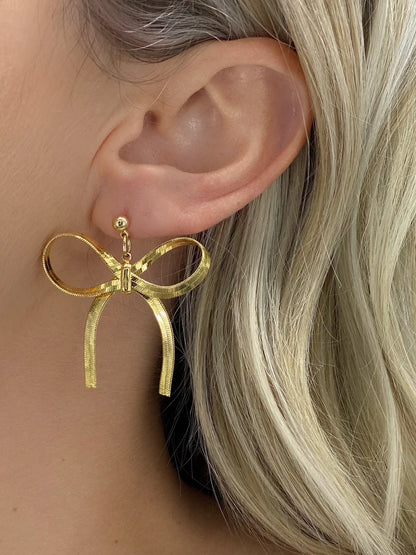 Gifted Bow Statement Earrings in gold by Farrah B